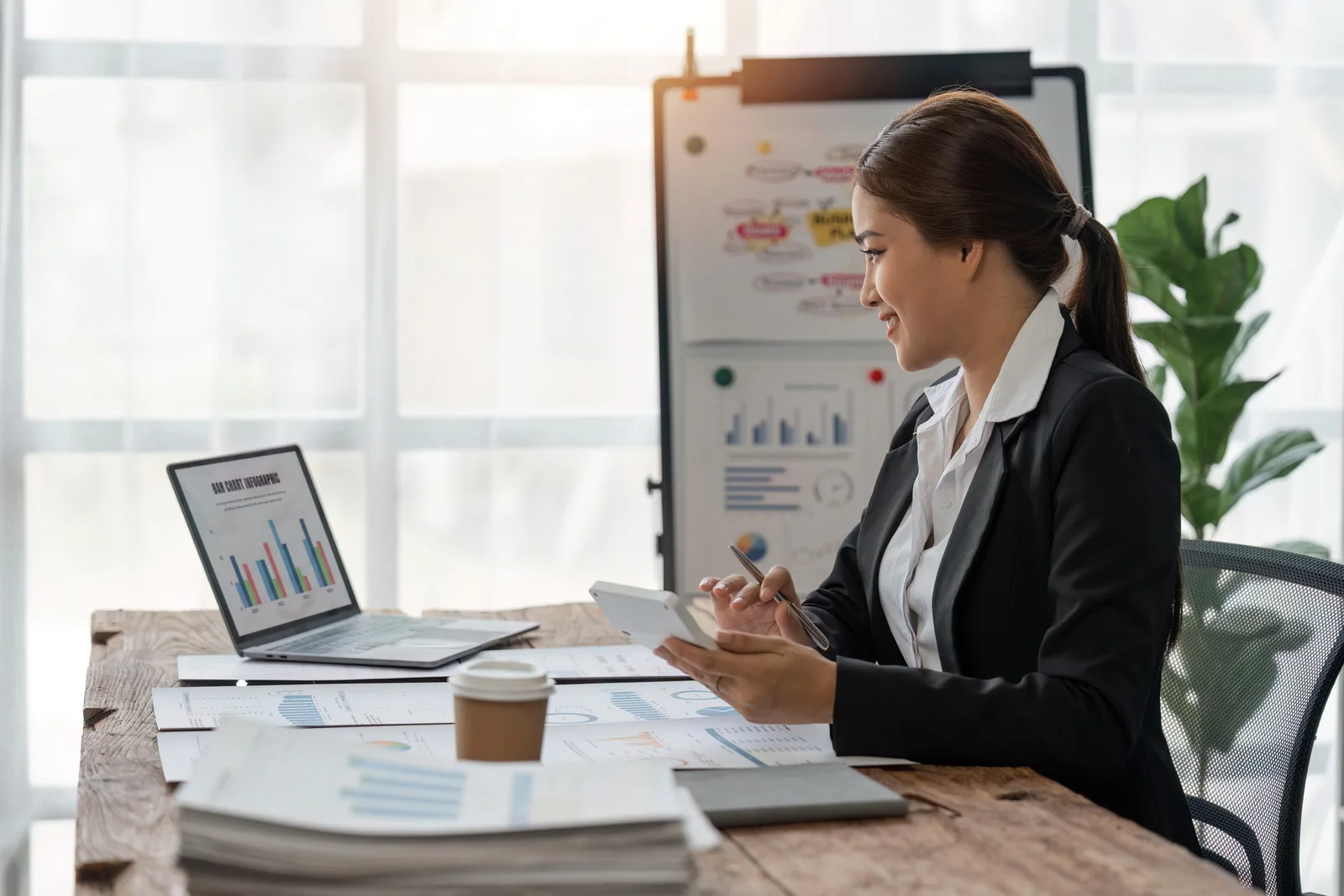 Businesswoman analyzing data at desk.