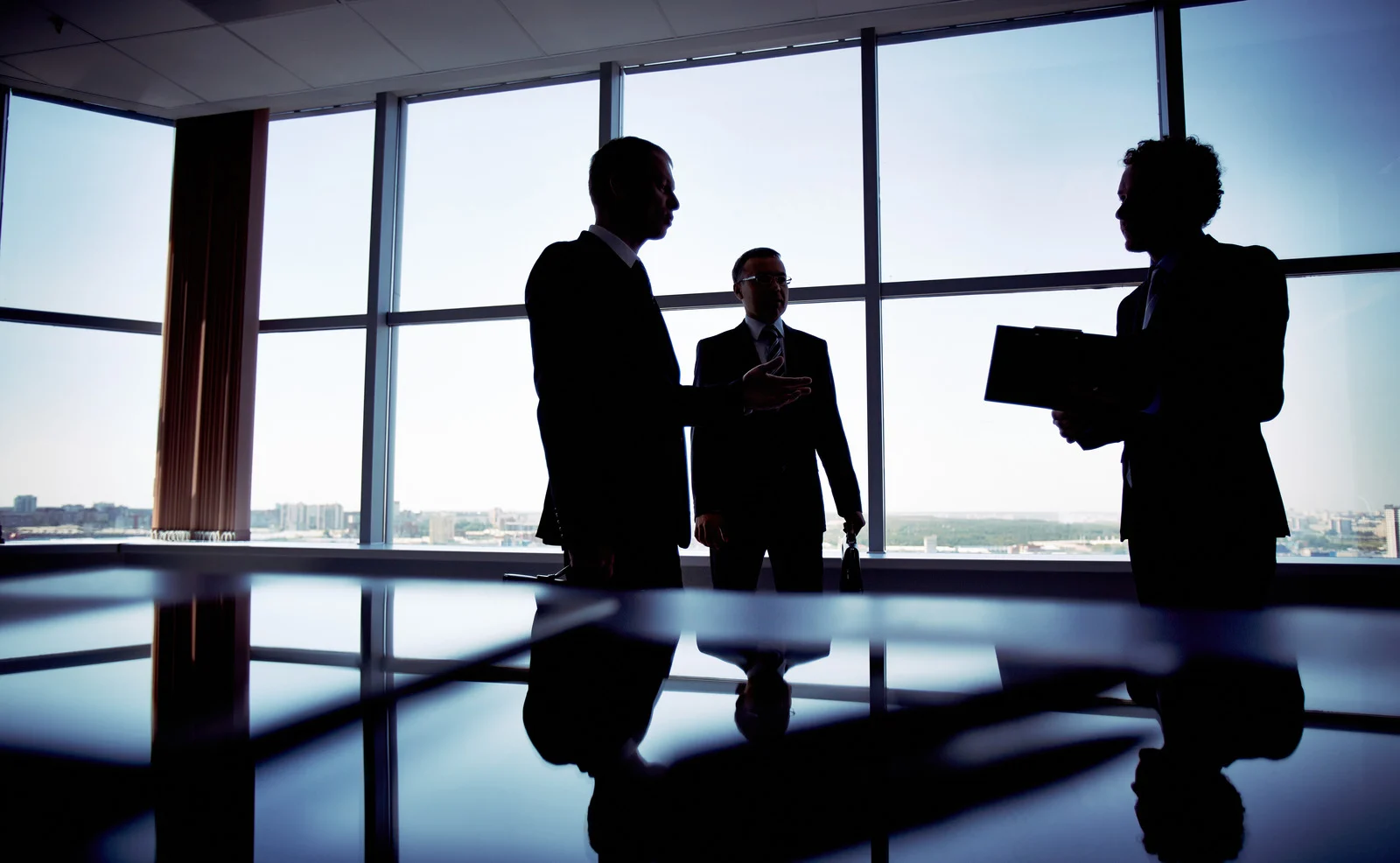 Business partners shaking hands over formation paperwork