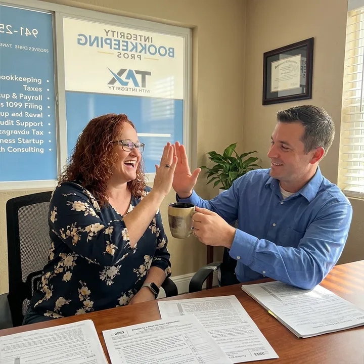 business tax strategist Sarasota, a Tax with Integrity co-owner celebrating a completed S-Corp election with a business owner client