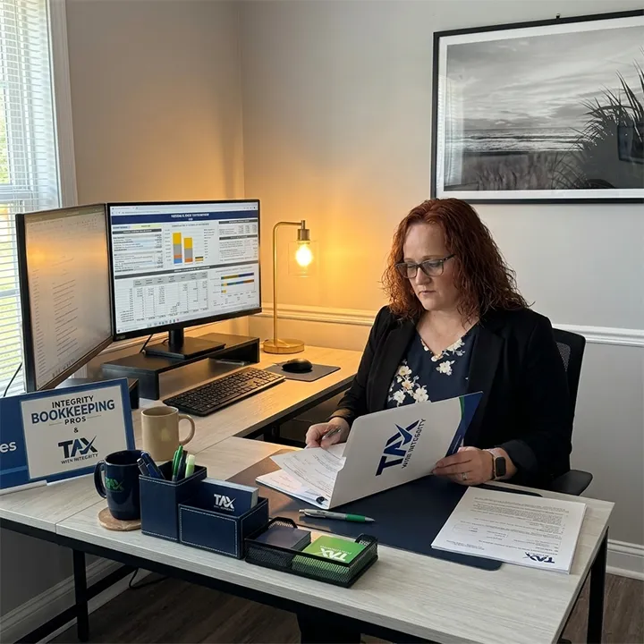 business tax strategist Sarasota, a Tax with Integrity co-owner reviewing a business owner's tax overview dashboard